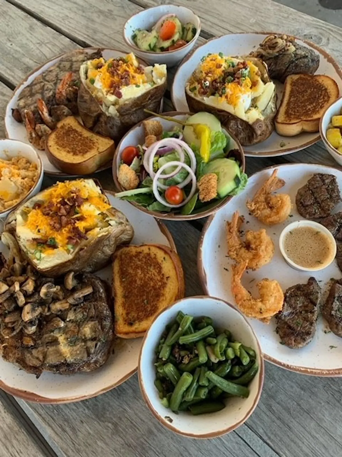 a wooden table topped with different types of food on a plate